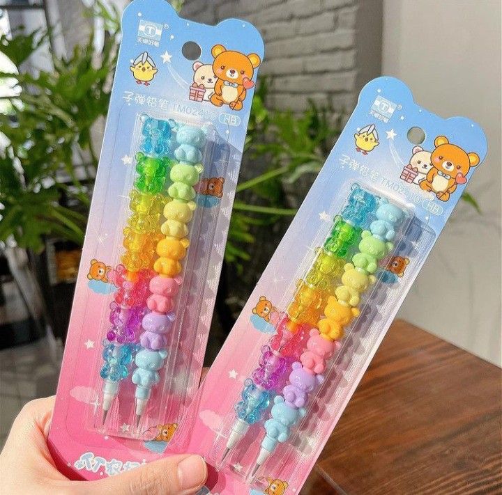 two plastic toothbrushes with different colored beads on them