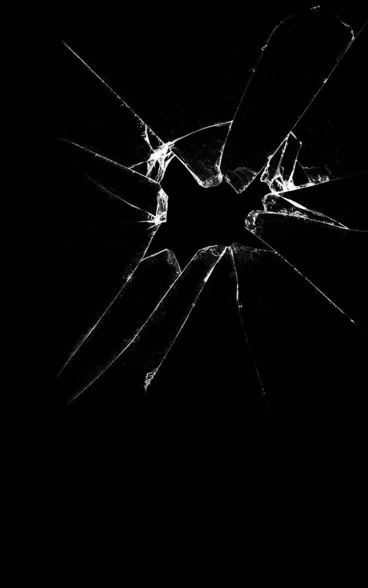 a broken glass window in the dark