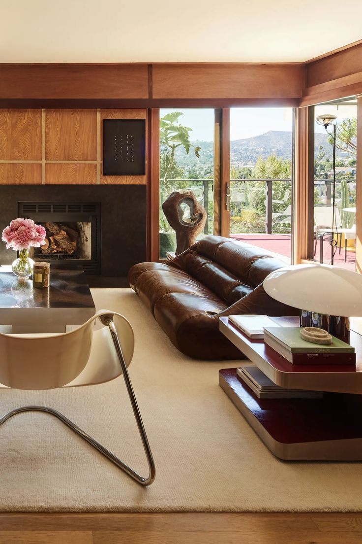 a living room filled with furniture and a fire place in the middle of a room