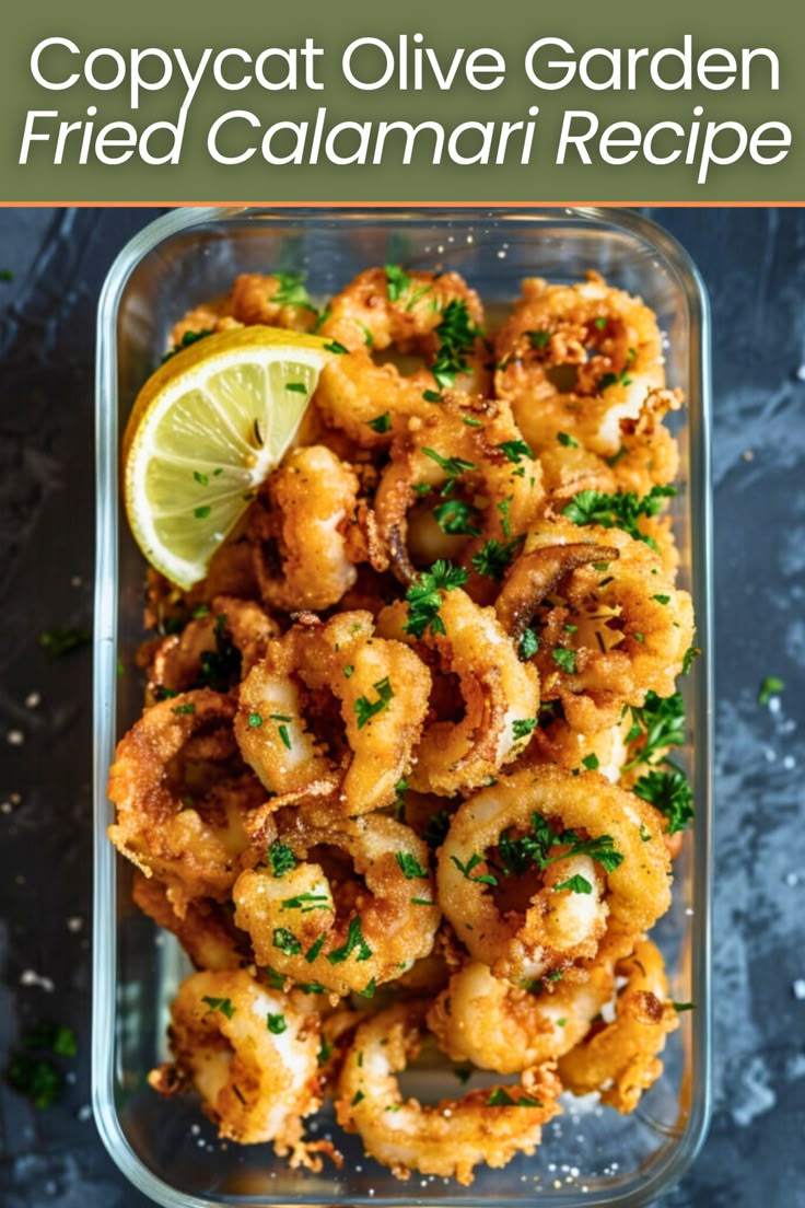 a glass dish filled with fried calamari and garnished with parsley