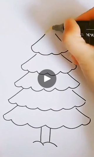 someone is drawing a christmas tree on paper