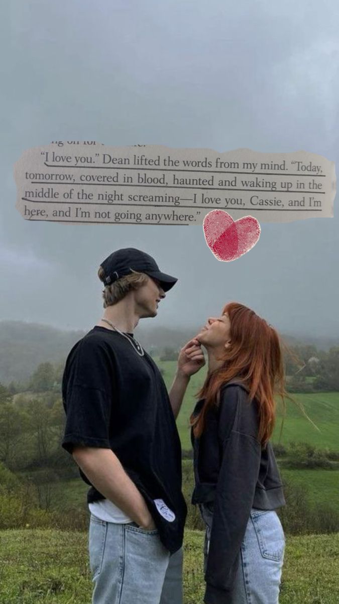 a man and woman standing next to each other in front of a sign that says i love you