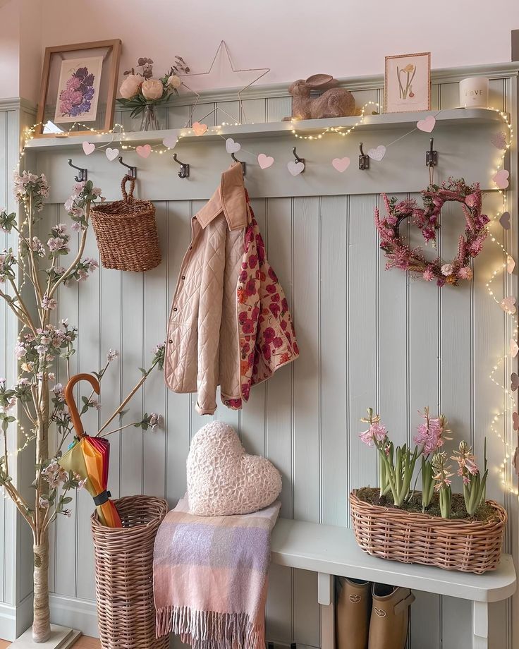 a coat rack with baskets and umbrellas hanging on it's wall next to a bench