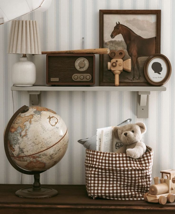 a teddy bear sitting on top of a pillow next to a wall mounted clock and radio