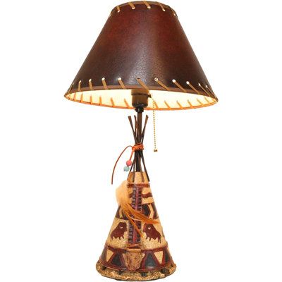 a lamp that is sitting on top of a wooden base with a brown shade over it