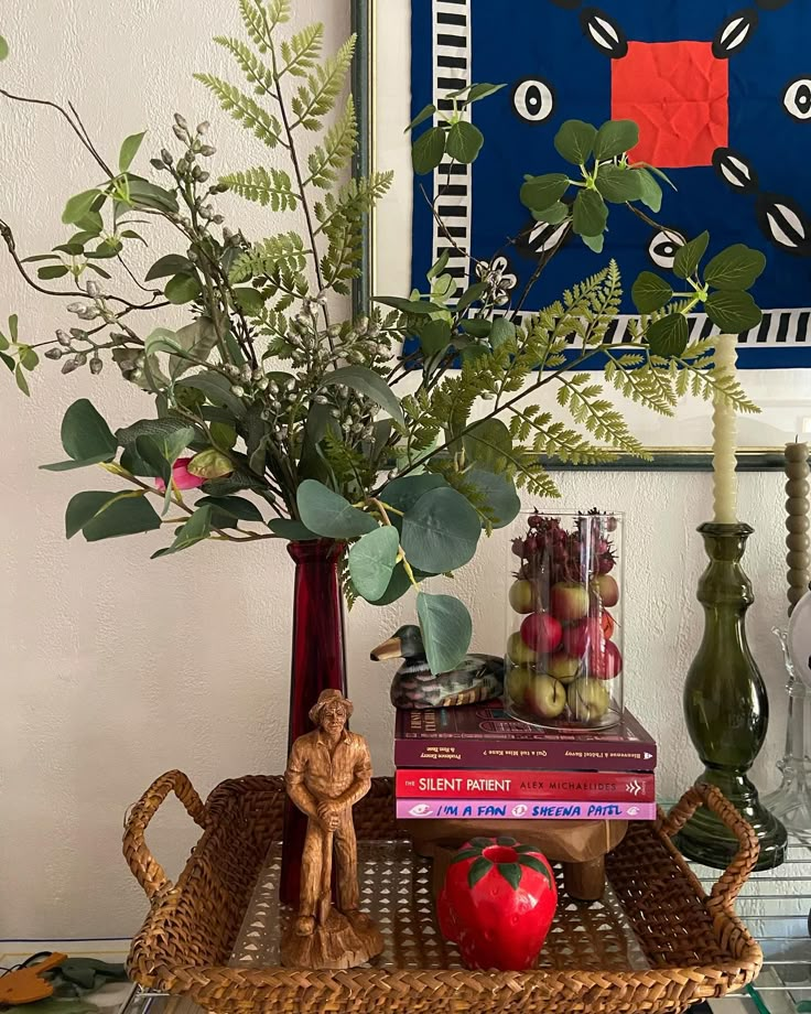 there is a basket with books and vases on it