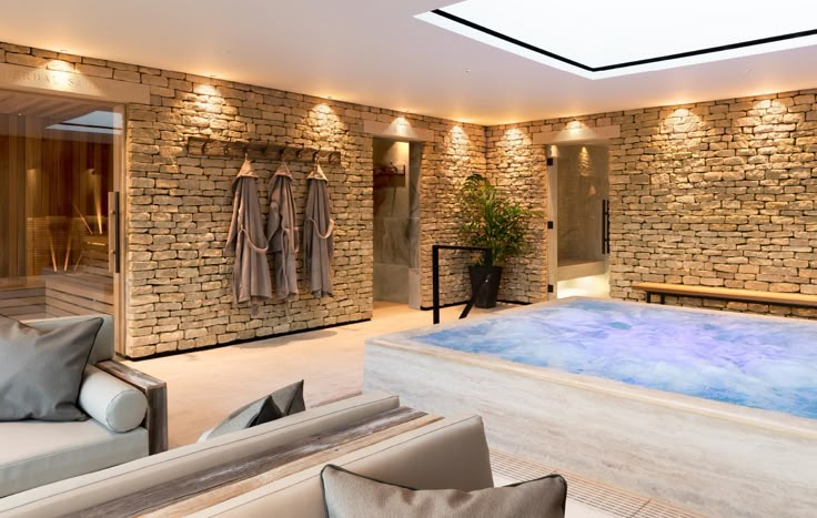 an indoor hot tub in the middle of a room with two couches and chairs