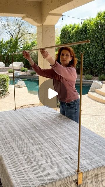 a woman standing on top of a bed next to a pool