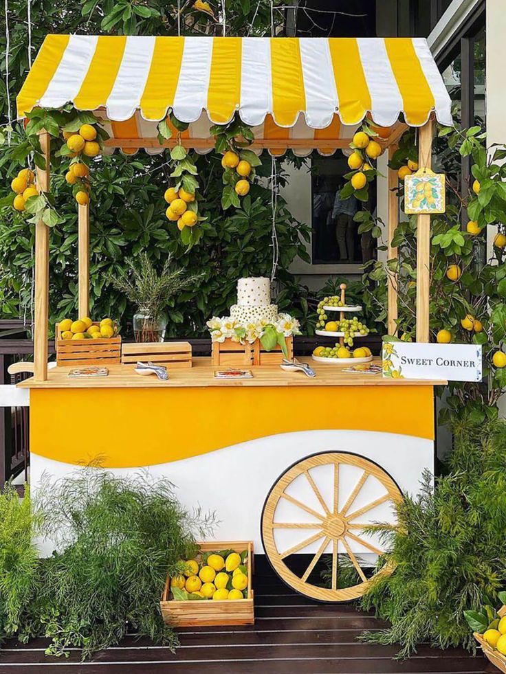 a lemonade stand with yellow and white awnings on it's sides