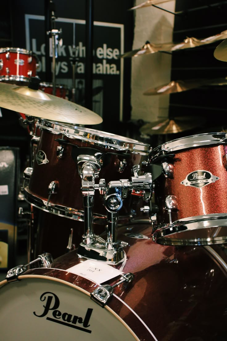 a red drum set sitting on top of a wooden floor