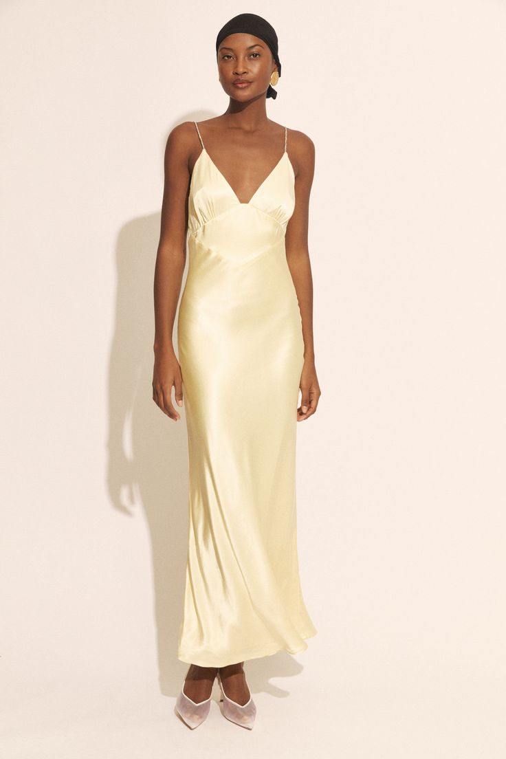 Ethereal elegance. The golden hue and diamante-encrusted straps are inspired by the ebullient romance of a sunset in Capri. An ode to love ever-after, this gown is imbued with whimsy and sultry sophistication

SIZING: True to size. AU: Model wears a size 8 / US: Model wears a size 4.

FABRICATION: Main: 100% Viscose. Lining: 100% Polyester.

- Diamante-encrusted straps
- Triangle neckline
- Deep V back Elegant Yellow Silk Slip Dress, Gold Summer Evening Dress For Gala, Elegant Yellow Evening Slip Dress, Elegant Yellow Slip Dress For Evening, Glamorous Slip Dress For Wedding And Prom Season, Glamorous Wedding Slip Dress With Spaghetti Straps, Gold Spaghetti Strap Evening Dress For Wedding, Luxury Summer Gown, Elegant Yellow Satin Gown