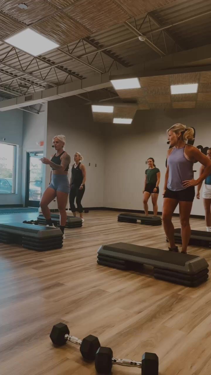 a group of people in a gym doing exercises