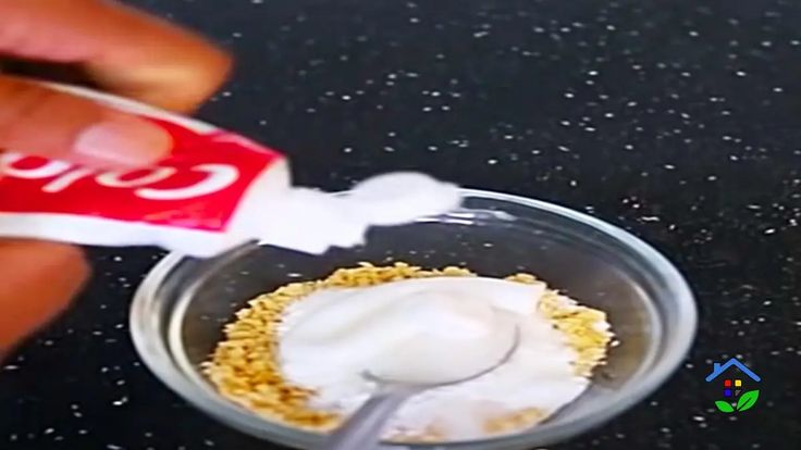 a person is dipping some food into a small bowl with a spoon and a can of soda