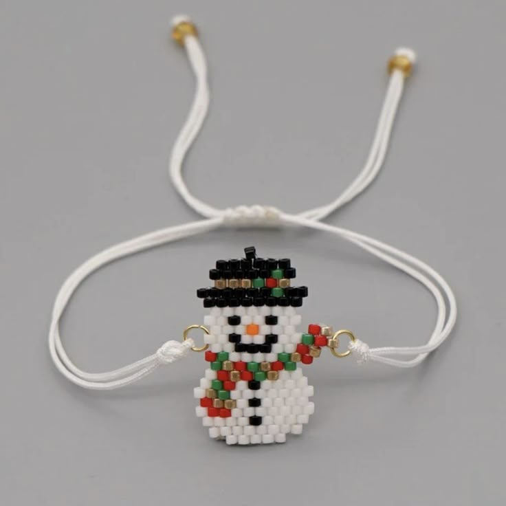 a beaded snowman bracelet with white cords