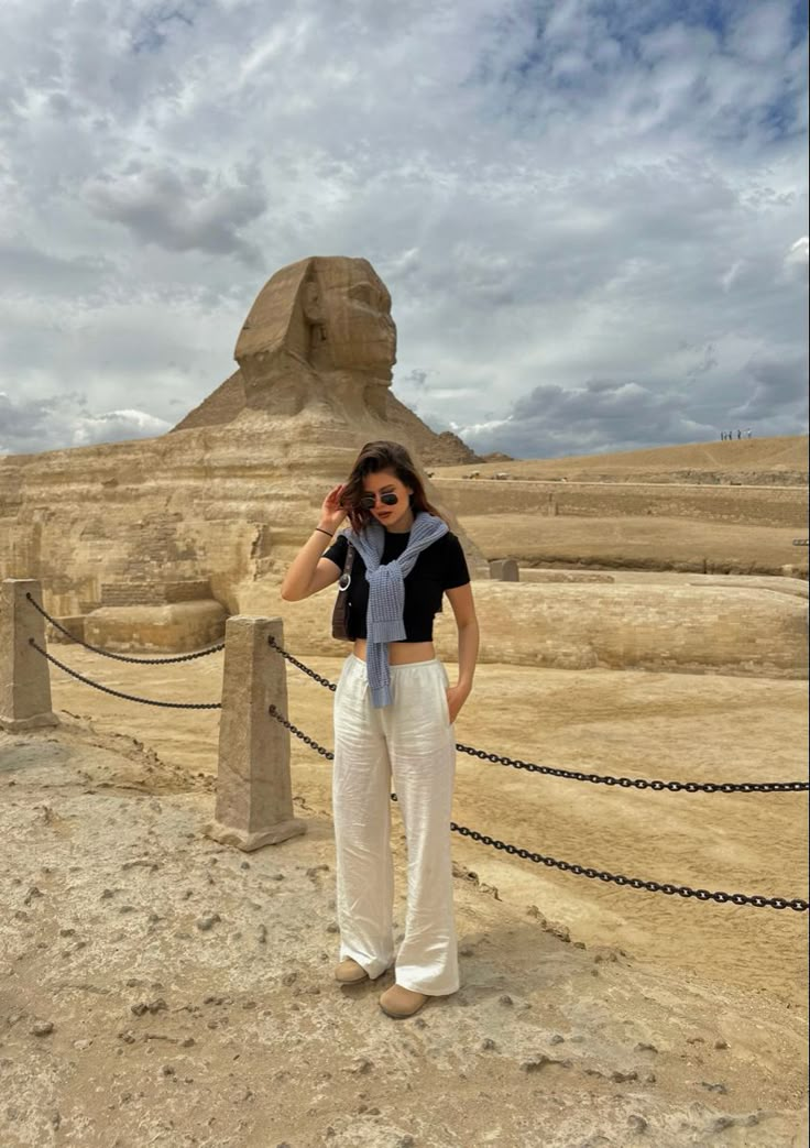 a woman standing in front of the great sphinx