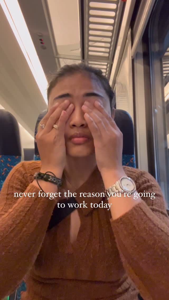 a woman covering her eyes while riding on a train with the caption never forget the reason you're going to work today