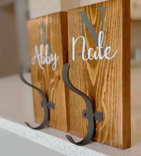 two wooden signs that are on top of a shelf with the letters n and y