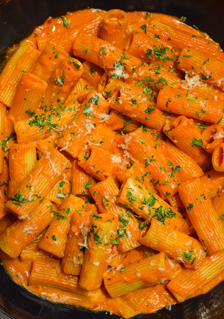 pasta with sauce and parmesan cheese in a skillet