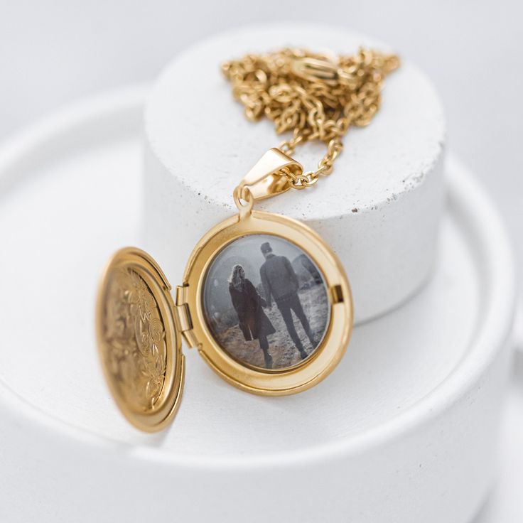 Oval Photo Locket Necklace - a timeless and cherished keepsake to hold your loved ones near. The Oval Photo Locket Necklace is the ideal gift for those who treasure their closest connections. Featuring an elegant oval-shaped locket, it securely holds a photo or memento of a dear one, allowing you to carry their presence close to your heart. This exceptional piece makes a thoughtful gift for any occasion, such as birthdays or anniversaries, and can be further personalized with engraving for added sentiment. The Oval Photo Locket Necklace is a distinguished and sentimental addition to any jewelry collection, embracing its timeless design and inherent emotional value. 💬 Please send us your image via direct messages. 📣 Additional information about the product 👉 Material: Stainless steel 👉 Personalized Medallion Jewelry As Gift, Wedding Pendant Necklace With Engraving Option, Locket Necklace For Mother's Day, Anniversary Gift Medallion Locket Necklace, Medallion Locket Necklace For Anniversary Gift, Gold Necklaces With Engraving Option For Anniversary, Anniversary Jewelry Locket Round Pendant, Anniversary Locket Round Pendant Jewelry, Gift Charm Necklace With Coin Medallion Pendant