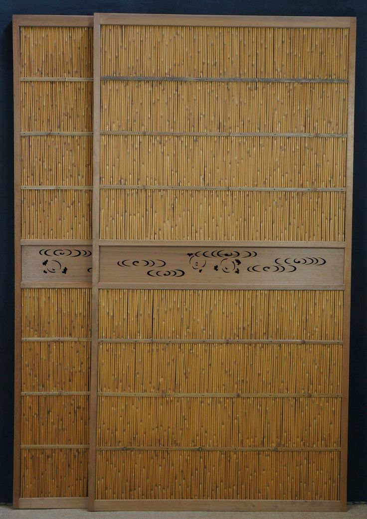 two bamboo doors with writing on them