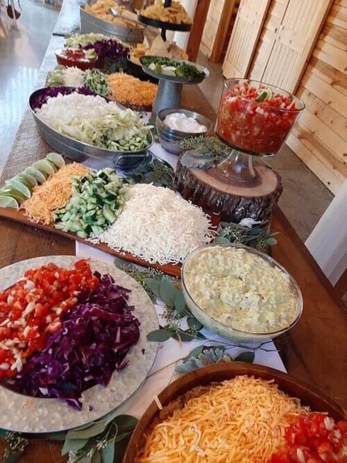 many different types of food are laid out on the buffet table for people to eat