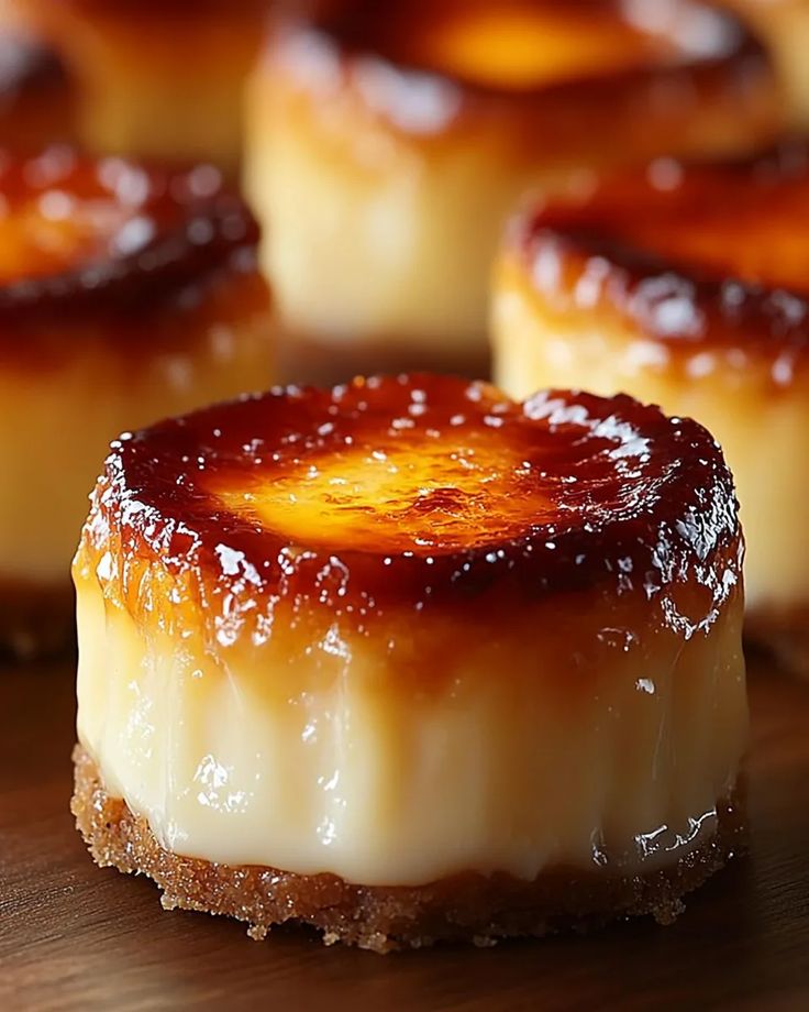 small desserts with jelly on them sitting on a wooden table top, ready to be eaten