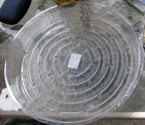 a clear plastic plate sitting on top of a table next to scissors and other items