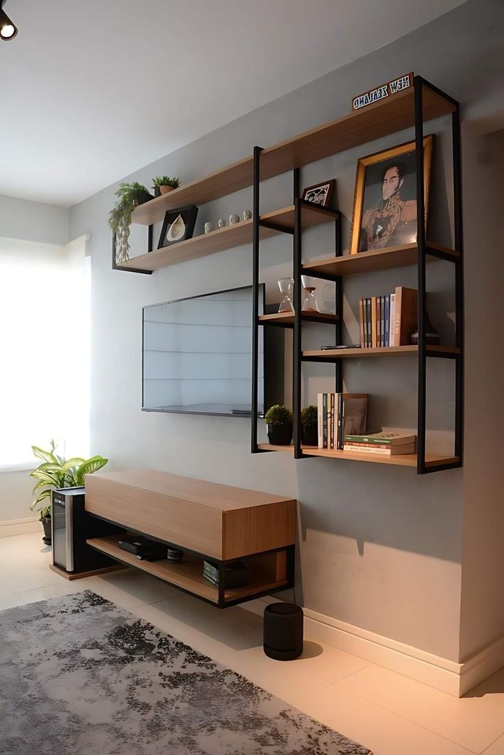 a living room filled with furniture and a flat screen tv mounted on a wall next to a window