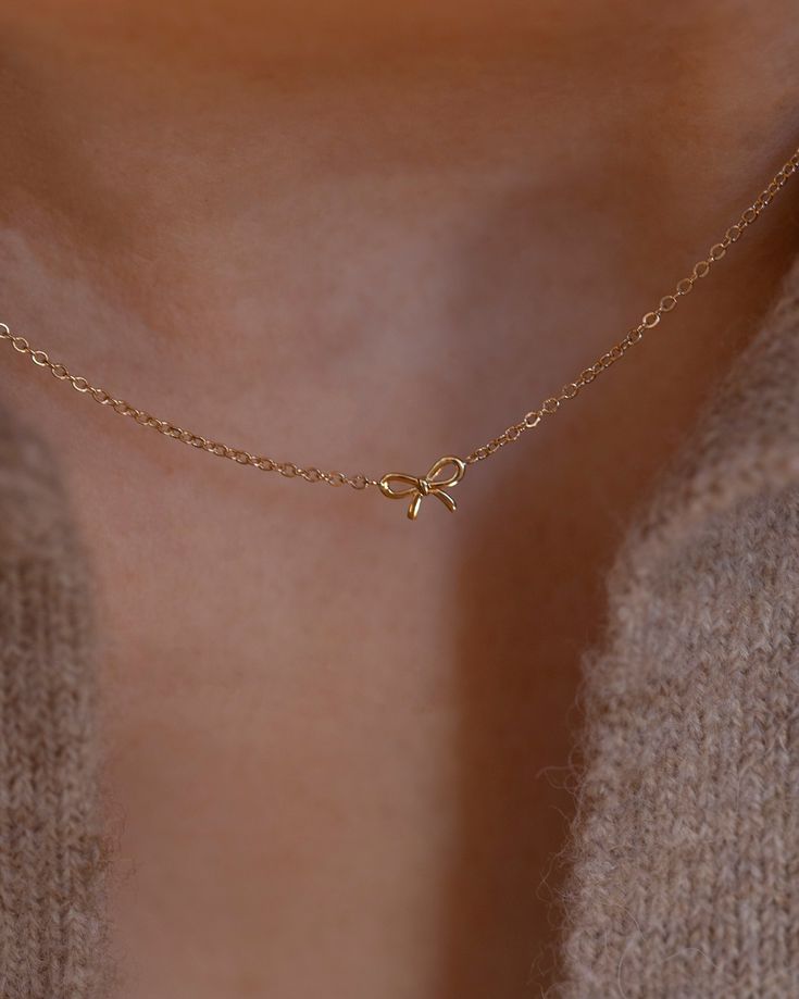 Discover the charm of the coquette era with our 14k Gold Dainty Bow Necklace. The small, delicate bow is ideal for everyday wear, making it a must-have accessory. • 14k Yellow Gold• Bow measures about 6mm Elegant Tiny Charm Necklaces In 14k Gold Filled, Handmade Gold Necklace, Preppy Jewelry, Pretty Jewelry Necklaces, Small Necklace, Set Earrings, Jewelry Accessories Ideas, Bow Necklace, Gold Necklace Set