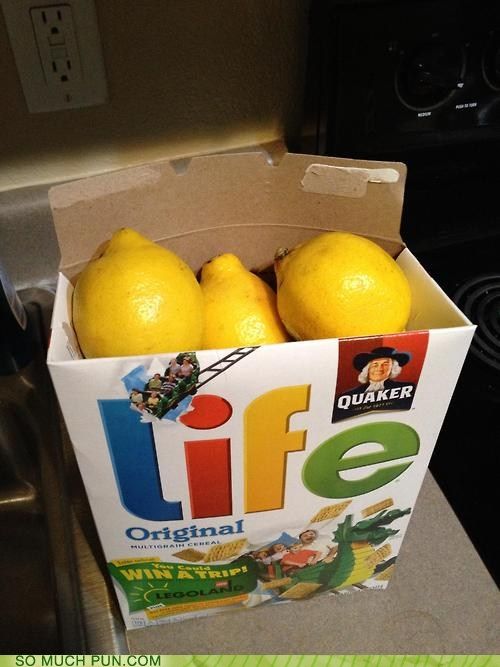 a box filled with lemons sitting on top of a counter next to a stove