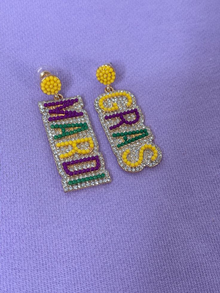 Get ready to dazzle at your next Mardi Gras parade with these purple, green, and gold rhinestone earrings! Add a touch of sparkle to your outfit and let the good times roll with these festive earrings. Perfect for celebrating in style! Gold Rhinestone Earrings, Mardi Gras Parade, Good Times Roll, Gold Rhinestone, Earring Sale, Rhinestone Earrings, Mardi Gras, Good Times, Sparkle