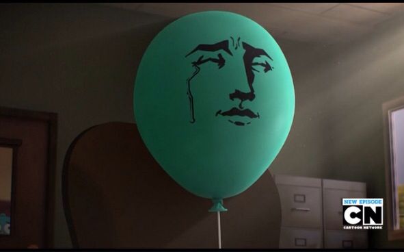 a green balloon with a drawing of a man's face on it