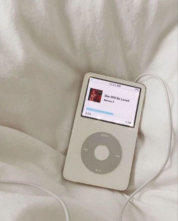 an ipod sitting on top of a white sheet