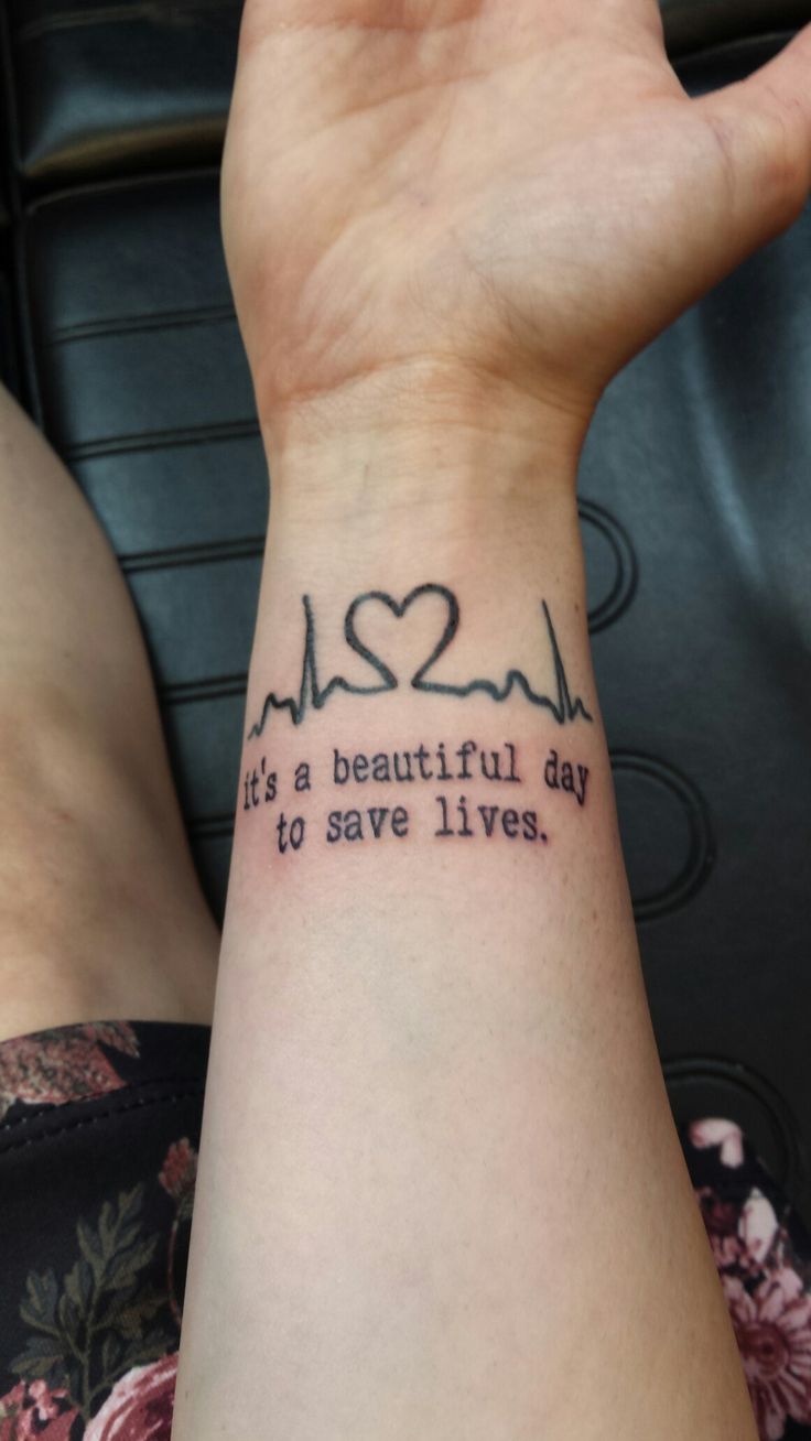 a woman's wrist with a tattoo saying it's a beautiful day to save lives