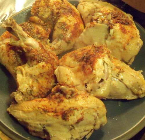 some chicken is sitting on a plate and ready to be cooked in the oven,