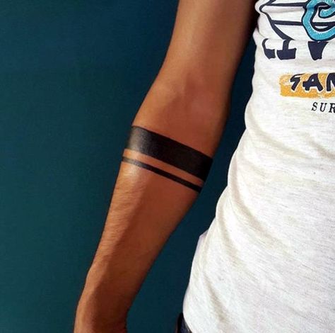 a man's arm with a tattoo on it and two lines in the middle