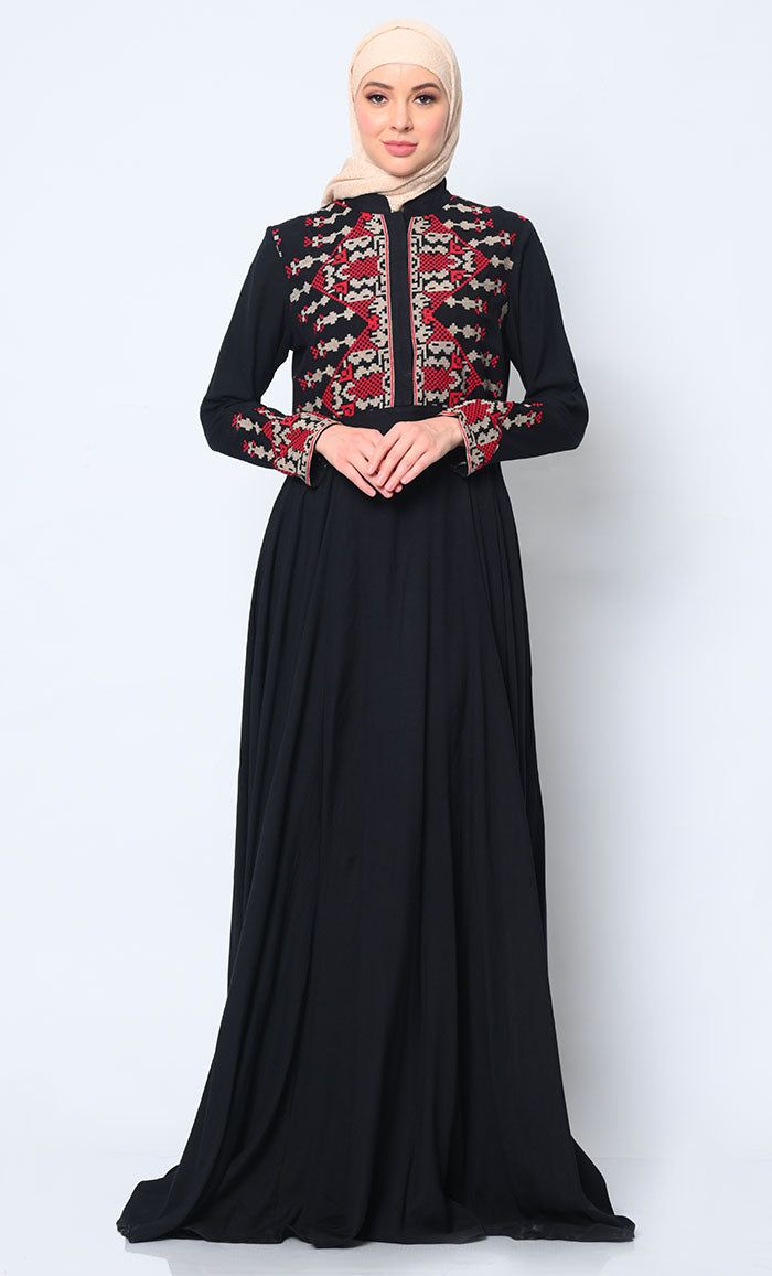 Discover the perfect fusion of elegance and practicality with our Women's Abaya, meticulously crafted to elevate your wardrobe. Featuring modern cross stitch embroidery on the bodice, this abaya exudes sophistication and timeless charm. The addition of two discreet pockets ensures functionality without compromising on style, providing ample space to keep essentials close at hand. Designed for effortless sophistication, a hidden button placket maintains a clean, streamlined front, while waist gathers create a graceful drape that enhances the figure beautifully. A refined stand collar completes the look with understated elegance, framing the face with finesse. Crafted from premium fabric, this abaya promises luxurious comfort and versatility, making it an essential piece for both formal occa Traditional Long-sleeve Abaya With Intricate Embroidery, Traditional Long Sleeve Abaya With Intricate Embroidery, Traditional Abaya With Intricate Embroidery And Long Sleeves, Black Embroidered Floor-length Abaya, Festive Black Embroidered Thobe, Traditional Black Embroidered Thobe, Traditional Long Sleeve Abaya With Resham Embroidery, Long Sleeve Abaya With Intricate Embroidery For Eid, Traditional Abaya With Chikankari Embroidery For Eid