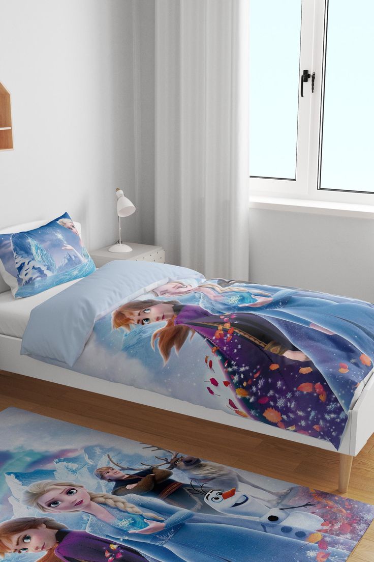 a bed with a frozen princess comforter on it