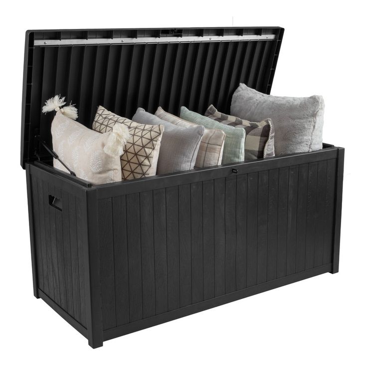 a black storage box filled with lots of pillows