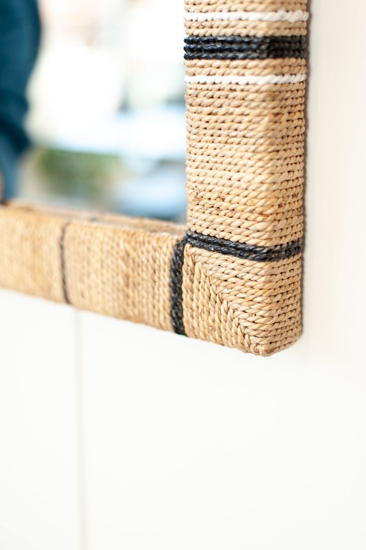 a close up of a basket hanging on the side of a wall with a person in the background