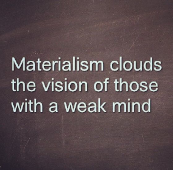 the words materialism clouds the vision of those with a weak mind on a blackboard