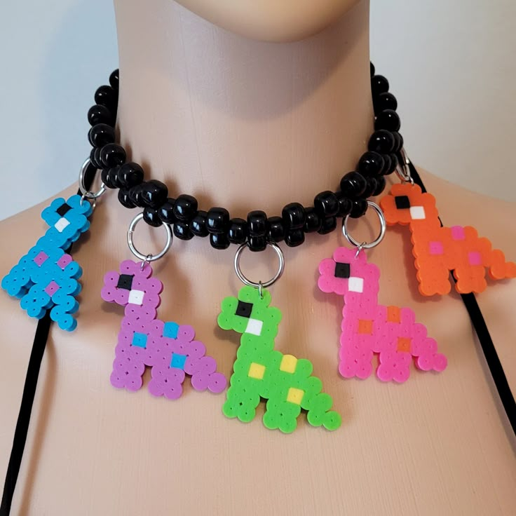 These kandi necklaces are made with pony beads and dinosaur charms. One size fits all. This Item adjust up to 17 Inches.  This Item is made to order. Perfect for any event! You will get lots of compliments in this unique wearable art! Stand out at your next event! Edm festival  Raves Party  Rave outfit  Festival outfit Pride Adjustable Rave Style Choker, Adjustable Multicolor Rave Choker, Rave Multicolor Choker For Festivals, Rave Style Multicolor Choker, Rave Diy Outfits, Kandi Necklace Ideas, Kandi Necklaces, Kandi Choker, Rave Necklace