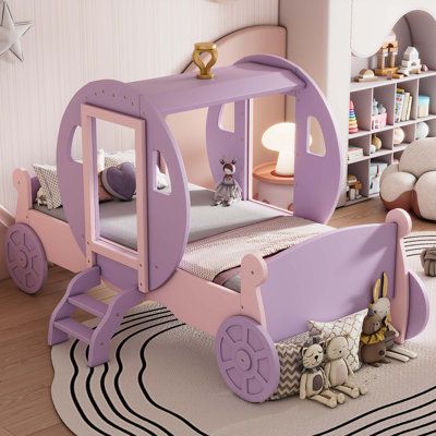 a child's bedroom with a pink and purple train bed, white rugs and bookshelves