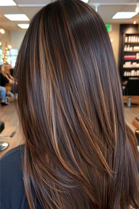 This long layered style features rich chocolate brown tresses accented with warm caramel highlights. The seamless blending of shades really stands out in this straight style. Click here to see more chocolate brown hair color ideas.