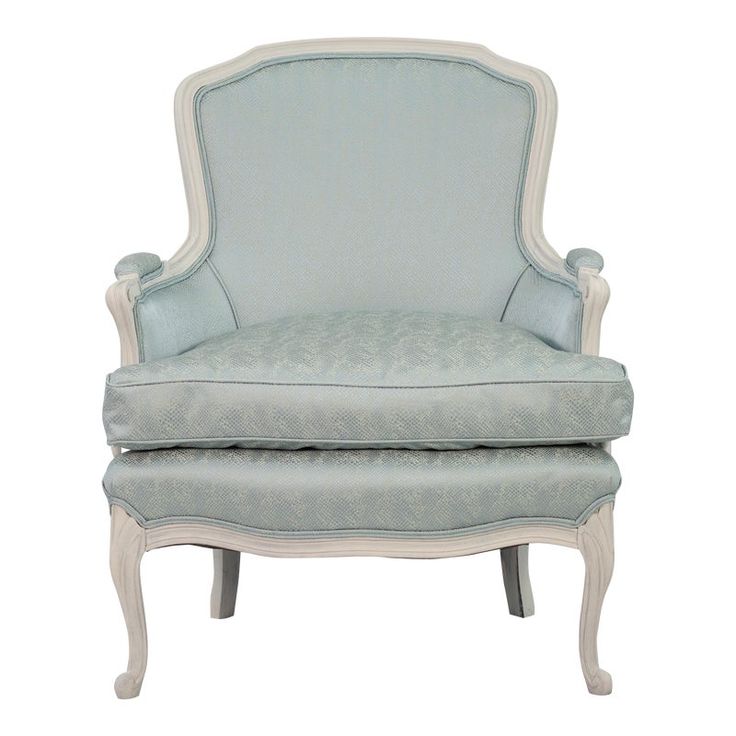 an upholstered blue chair with white trim