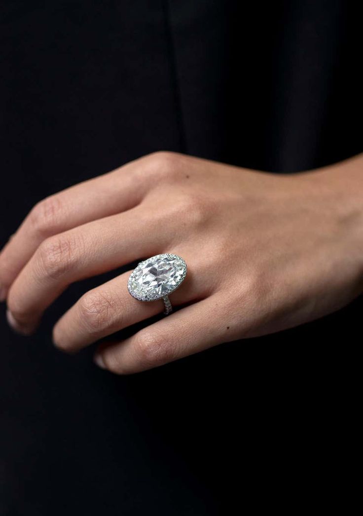 a woman's hand with a diamond ring on it