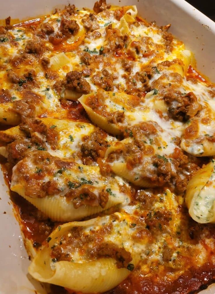 a casserole dish with meat, cheese and sauce