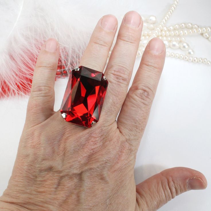 Huge Red Stone Ring, Ruby Crystal Ring, Light Siam ring Red Ring Huge Big Stone Cocktail Oversize rectangle Crystal Ruby Cherry True Red Men Adjustable Ring Statement Wedding Jewelry,Light Siam,SR84 This is a WOW bling ring! So big, sparkly but yet comfortable and adjustable made with top quality XXL (37mm x 25.5mm) rectangle octagon premium crystals . The setting is custom design for my studio, soldering and metal coating are done in Israel. This one is a real Head-turner! No one can ignore the Red Open Ring Crystal Ring As Gift, Red Gemstone Rings For Party, Red Emerald-cut Ring For Gift, Red Crystal Open Ring For Gift, Party Ruby Gemstone Rings, Emerald Cut Red Ring For Gift, Gift Red Crystal Open Ring, Elegant Red Crystal Ring For Party, Red Square Cut Jewelry Gift