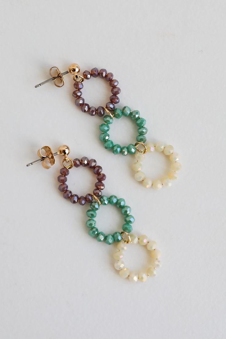 two pairs of earrings with pearls and beads hanging from the end of each earring