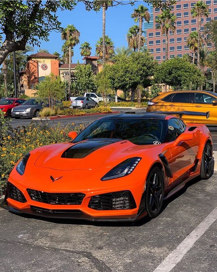 an orange sports car parked on the street